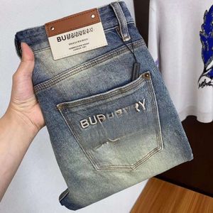 Designer jeans vår/sommaren förenklade europeiska mäns jeans high end trendiga varumärke tungt hantverk tvättade europeiska varor elastiska smala passform små ben jeans