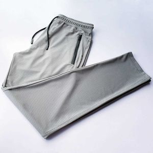 ゆるいサイズの夏の新しいメッシュアイスカジュアルメンズパンツズボン薄いスタイルクイック乾燥通気性9ポイントストレートスウェットパンツ