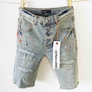 Jeans viola di marca stile americano con bordi grezzi e buchi, pantaloncini in denim lavato da uomo