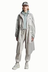 The latest launch of the Mon designer women parka is in light tones and is made of fine tear-resistant nylon fabri hooded waist-fitting sun protection long windbreaker