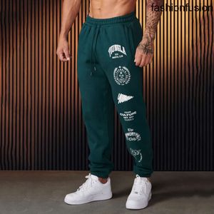 Jogger męskie dresowe wiele w stylu amerykańskim Gym Sport Fitness Bawełniane spodnie swobodne spodnie wydrukowane Środkowa talia Dripstring 240125