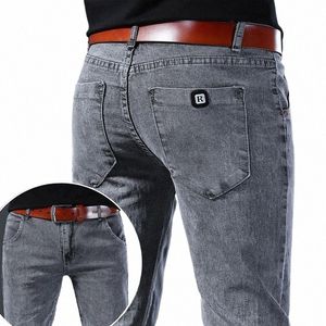 Graue Denim-Jeans-Männer nehmen elastische Hosen-Grau-Fi-Frühlings-Sommer-Herren-LG-dünne High-Street-kleine Füße-Hosen R6Z0 # auf