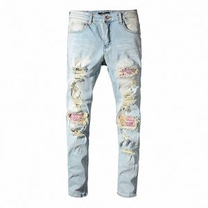 McIKKNY Mężczyźni rozerwali plisowane dżinsowe spodnie FI Patch Patchwork Dżinsowe spodnie dla męskiej streetwearu t79t#