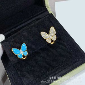 Designer Charm Gold High Edition Van Butterfly örhängen för kvinnor Asymmetriska blå emalj Full diamant med premium fyra bladgräs
