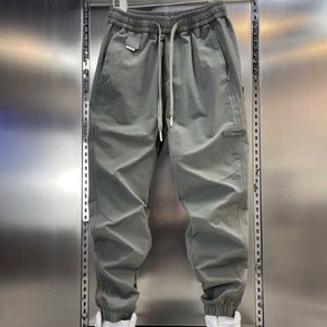 2023 Autunno Nuovo Prodotto Uomo Dimagrante Slim Fit Piedi Piccoli Pantaloni Sportivi Elastici Cravatta Pantaloni Gamba Ha Versatili Pantaloni Casual di Colore Solido