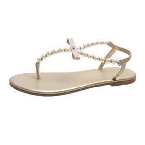 Sandały Summer Women 2023 Nowy moda płaska plaża na świeżym powietrzu Sexy Pearl Bow-Wkrzyń Buty żeńskie klip nutki klapki slajdy H240328VEHX