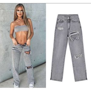 jeans in stile creativo di tendenza stradale con buchi divisi pantaloni svasati da donna grande