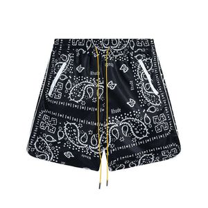 Rhude vävd nylon dubbelskiktshorts med cashewblomma över hela kroppsbokstäverna avslappnade sport snabbtorkande sandmens och kvinnors strandbyxor