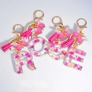 Tornari percorsi di gancio Flower glitter secchi 26 lettere Pendant Tornario farfalla rosa fasciatura iniziale borse ornamenti per carrelli d'auto