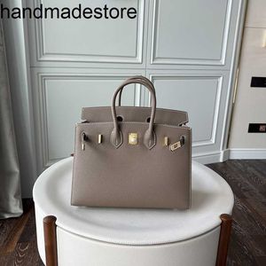 Platinstil Äußere Handtasche Naht Palm Muster Bag Gold Knopf Mode Handtasche Cowhide One Schulter Messenger Bag Button Frauenbeutel handgefertigtes echtes Leder