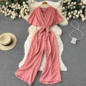 Kvinnors jumpsuits Rompers 2024 V Neck Jumpsuits Summer Fe Oregelbundna Casual Rompers Women Wide Leg Summer Overalls Woman D240507