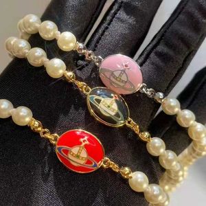 Designer Queen Mother Westwood Saturn emalj Series Oval Button Pearl Armband