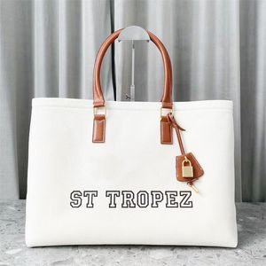 Mode kvinnor triomfes duk axel strand designer väska lyx handväska toppkvalitet stora totes väska mens canvas crossbody clutch weekender shopper väskor plånböcker