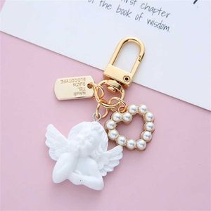 Keychains Lanyards Creative retro white angel keychain womens cute mini pearl heart-shaped keychain car keyring holder Trinket Bag charming jewelry J240509