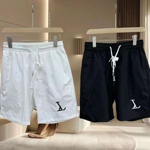 2024 Nya Eric Men's Mesh Swim Shorts Designer Mäns kvinnors basket Shorts som kör avslappnade jeans snabba torra byxor Lossa fotbollssport Black and White Quarter Pants