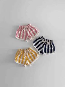 Shorts 2024 Summer New Baby Cotton Shorts Candy Color Baby Boys and Girls Striped Beach Shorts Preschool Leisure and Casual Clothing d240510