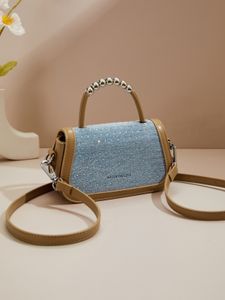Stay stylish and hands-free with this hot drill embellished crossbody bag