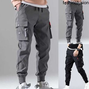 Jesienne mężczyźni Hip Hop harem joggery męskie spodnie męskie solidne wielopokomienne spodnie ładunkowe chude dopasowane spodnie dresowe 220811