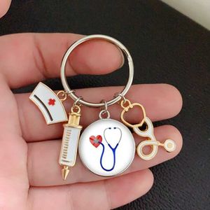 Keychains Lanyards New fashion creative nurse medical syringe stethoscope image keychain glass cabochon and glass dome key ring pendant gift Y240510