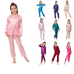 Pyjamas Wholesale Childrens Unisex Pyjama Set Girls and Boys Satin Pyjama Set Classic Pyjama Långärmad topp och byxor D58 D240515