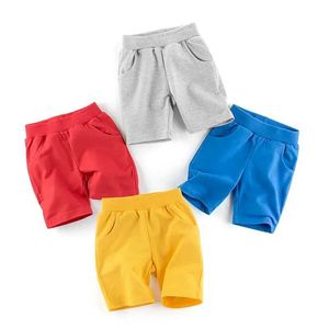 Shorts 2024 New Boys Shorts Solid Color Childrens and Girls Cotton Beach Shorts Sports Pants Childrens Elastic Waist Pants d240516