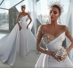 Eleganta sexiga pärlor sjöjungfru bröllopsklänningar ren långärmad kristaller juvel hals arabiska dubai brudklänningar med löstagbar kjol