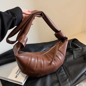 Nya ko crowdsourced mångsidiga väskor axeldesign äkta läder lyx crossbody horn 2024 kvinnor kesong väska instagram dumpling enstaka bulle