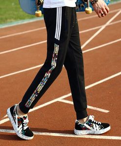 Nowa kolekcja elastyczne spodnie talii boczne paski spodnie męskie damskie mody joggers street noszenie dresowe spusty hip hopowe 8444479