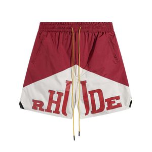 RHUDE 2024 SPRING/SUMMER NYCKLIG FÄRG BLOCK Tryckt basket Shorts för män och kvinnors fritidsmask Fempunktshorts Partihandlat 217