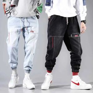 Spodnie męskie Trendy jogger męskie spodnie ładunkowe z lekkimi dżinsowymi kieszeniami ładunków hip-hop luźne czarne dżinsy krojenia królików męskie s-4xl 5xl Q240525