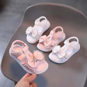 Sandalen Childrens Girl weicher Sohle Sommer Prinzessin Schuhe Anti -Slip -Bogen T Belt Strand Rosa Weiß D240527