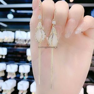 2024Korean style long tassel cats eye stone earrings with high-end feel lotus flower niche design and