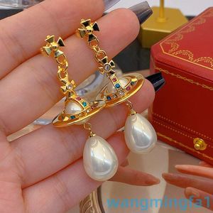 2024 Designer Luxury Xitai Queenjewellery Silver Needle Fashion Commuter Swallow Pearl Long Solid Earth Planet Color Zirconia örhängen