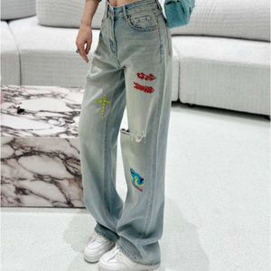 Mody projektantki streetwearu dżinsy kobiety szerokie kieszenie na wysokim talii z haftowym wzorem luźne dżinsy damskie