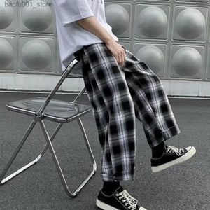 Calça masculina masculina roupas de rua lison com pernas largas e cintura elástica de calça esportiva solta calça calças de retalhos de retalhos xadrez q240529