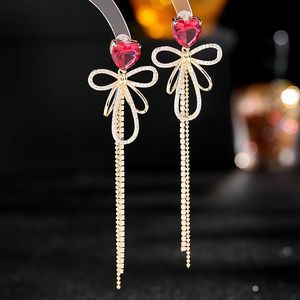 Корейские модные длинные висячие серьги с кисточками для женщин, ювелирные изделия в форме сердца с бантом, женский подарок 240401