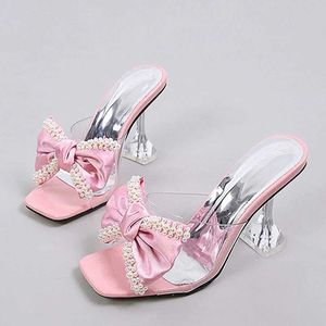 Sapatos de vestido 2024 novo estilo mulheres chinelos sandálias moda pérola bowknot salto alto pvc sapatos transparentes verão le slides bombas h240401