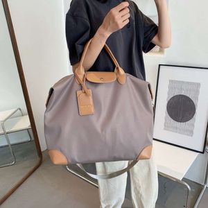 2024 Großkapazität Einkaufstasche Feiertage Reisetasche Frauen Reisetasche Neue Handtasche Nylon Big Bag Wochenendbeutel Gepäck über Nacht Beutel BolSO10a