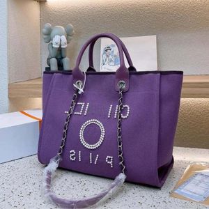 Neue Frauen Designer -Tasche Klassische Strandtasche Tasche große Kapazität Handheld -Tasche Luxus hochwertiger Mode vielseitig Perlmeister eingelegtes Design 6938