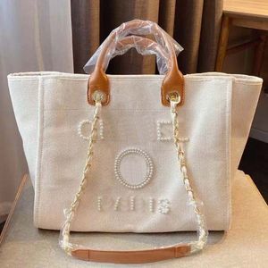 Heiße neue Designer -Tasche Klassische Strandtasche Tasche mit großer Kapazität Handheld -Tasche Luxus hochwertiger Mode vielseitige Perle eingelegtes Design Luxus -Tasche Sommer -Leinwandtasche