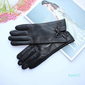 Fünf Finger Handschuhe Mode Frauen echte Lederschaffell -Bogendekoration Samtfutter in Winter schwarzen Handschuhen warm halten