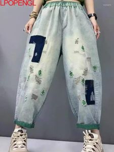 Kvinnors jeans kvinna vår och sommarhål Löst avslappnad orolig ankellängd elastisk midja streetwear denim harem byxor