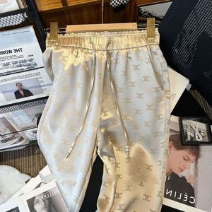 Pantaloni di pantaloni in vita elastici da donna con pantaloni lunghi in tessuto satinato con stampa a coregne