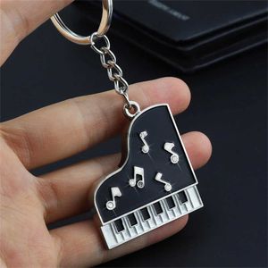 Keychains Lanyards Creative Piano Keychain Metal Note Earphone Key Ring Car Key Holder Purse Bag hänge