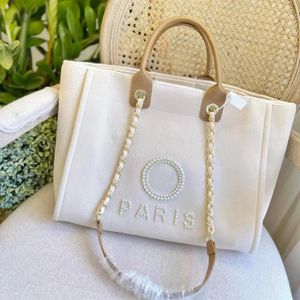Tygväska Kvinnor Designer Bag Classic Luxury Wind Versatile Embroidered Pearl Chain Beach Bags Stor shopping axelväska linne duk