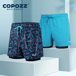 Copozz Men Swimming Trunks med kompressionsfoder 2 i 1 snabb torr baddräkt strandshorts dubbla lager som kör sportshorts 240416