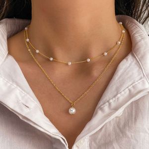 Fashionabla dubbelskiktade pärltasselhänge halsband för kvinnor