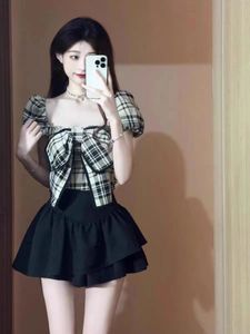 Camisa de manga curta xadrez francesa Summer feminino Nova versão coreana Design da cintura Bow Puff Sleeve Cropped top