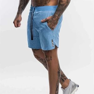 Mäns shorts 2024 Ny mens fitness och kroppsbyggande shorts för herr sommar gym träning män andas och snabb torkning av sportkläder långsam löpande strand shorts j240426