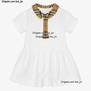 2023 Kleinkinder neue Kleidung Baby Kleid Kleid Sommer Kinderkinder Kurzarm Baumwollhemd Rock Klassische Plaid -Lappel importierten benutzerdefinierten Stoffe